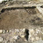Figure 19. Reoccupied surface of Room 6 facing south and showing hearth 5113 in northwestern corner.